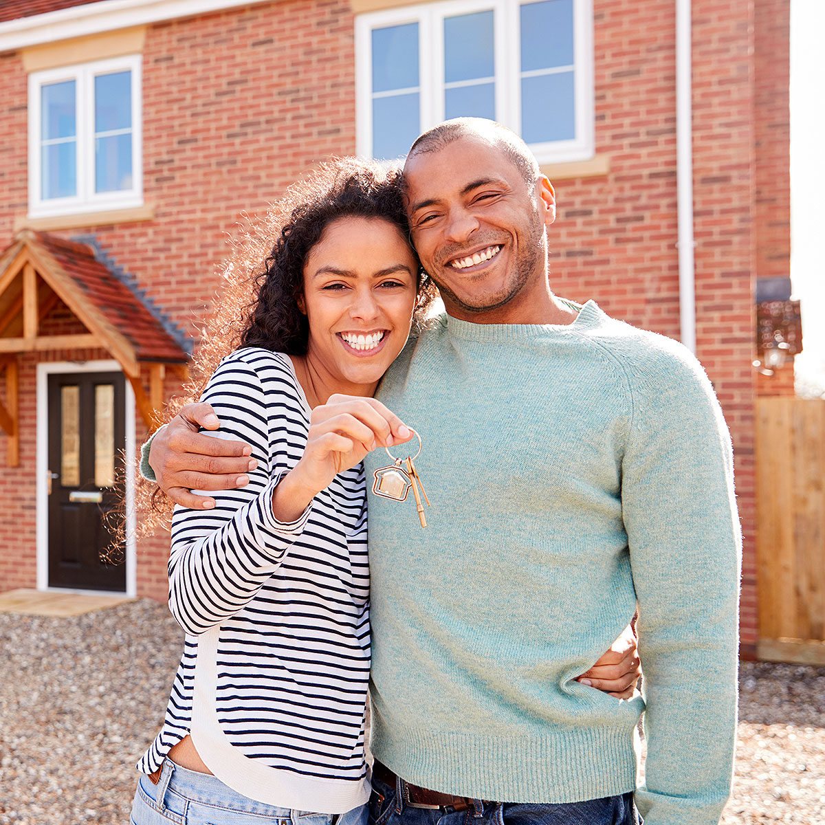 10-1-arm Couple in front of their house holding keys